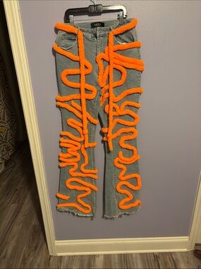 AKIRA Light Blue Denim Flare Jeans with Bright Orange Trim.